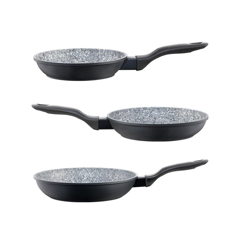 Baccarat stonex2 Ceramic non-stick frying pans of varying sizes with vegetables and a wooden spoon
