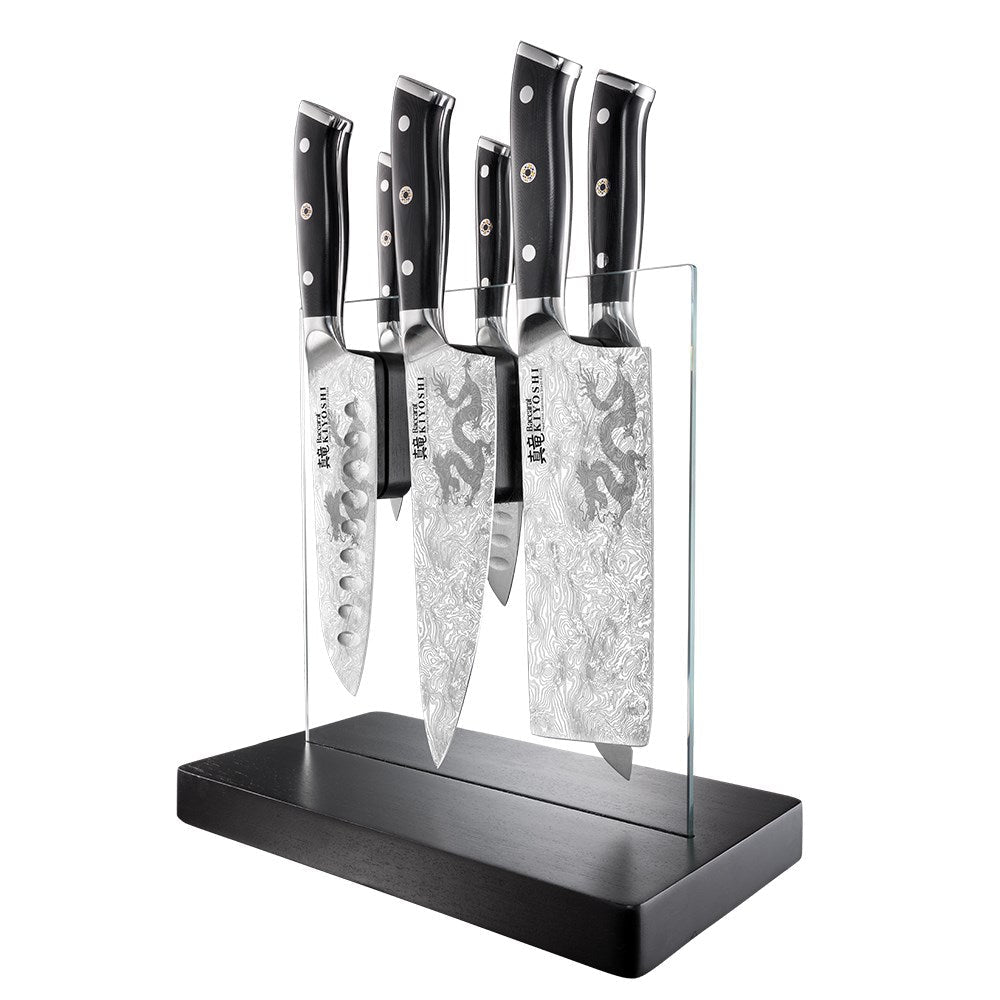Sleek stainless steel knives next to sliced mushrooms and garlic premium black handles - Baccarat