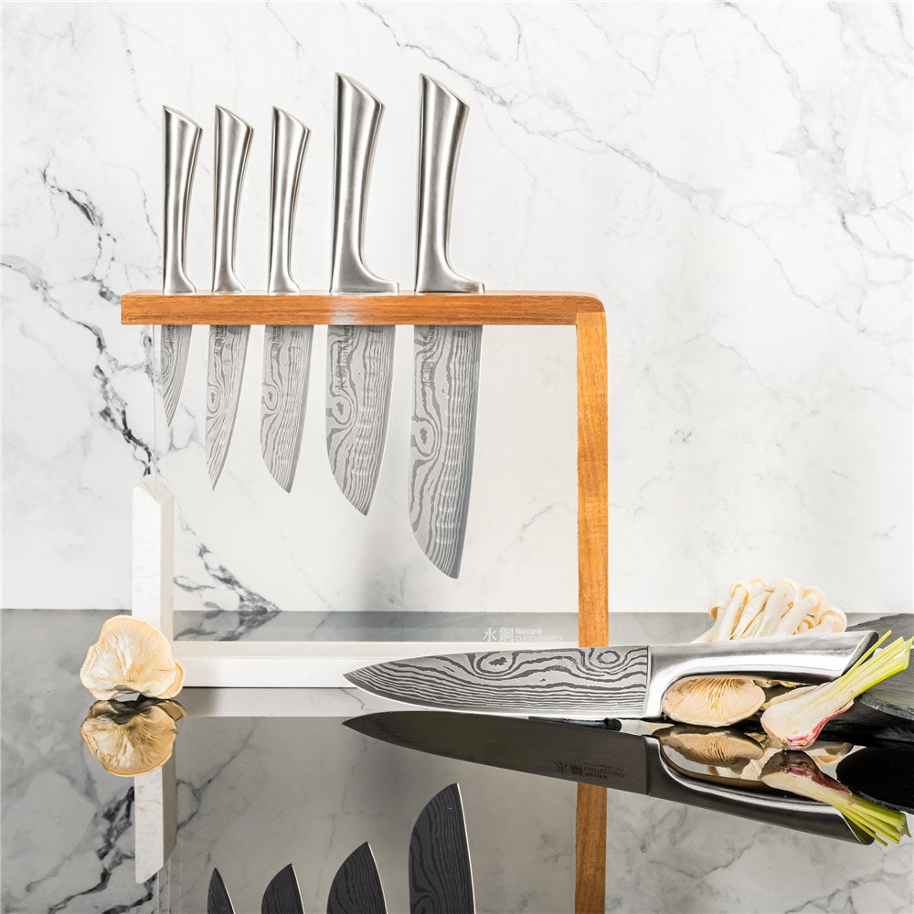 Baccarat Damashiro 7 piece knife block with stainless steel knives on a glossy counter - Baccarat