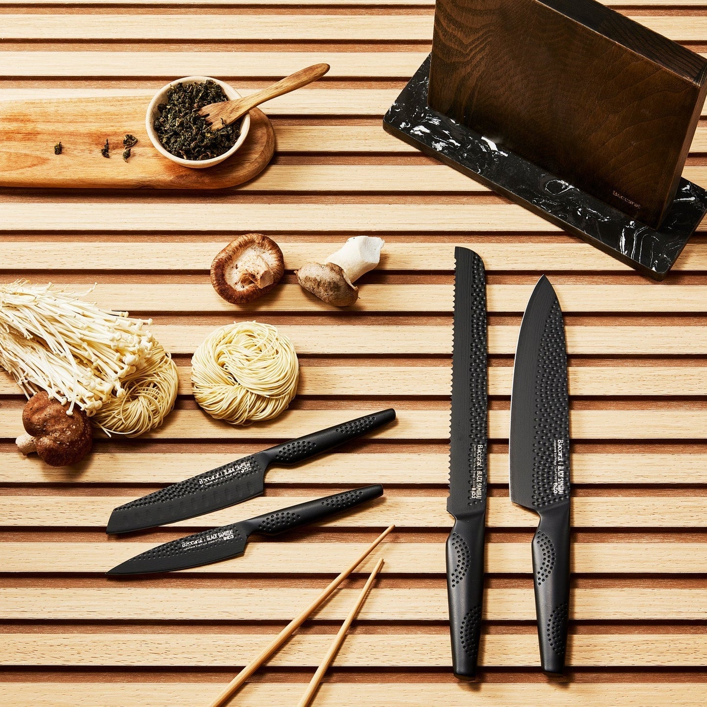 Close-up of two black kitchen knives in a wooden block textured handles colour knives - Baccarat ID3