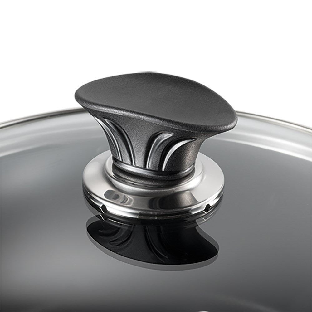 Close-up of a black lid with a sleek handle featuring a polished design - Baccarat Glass Cookware