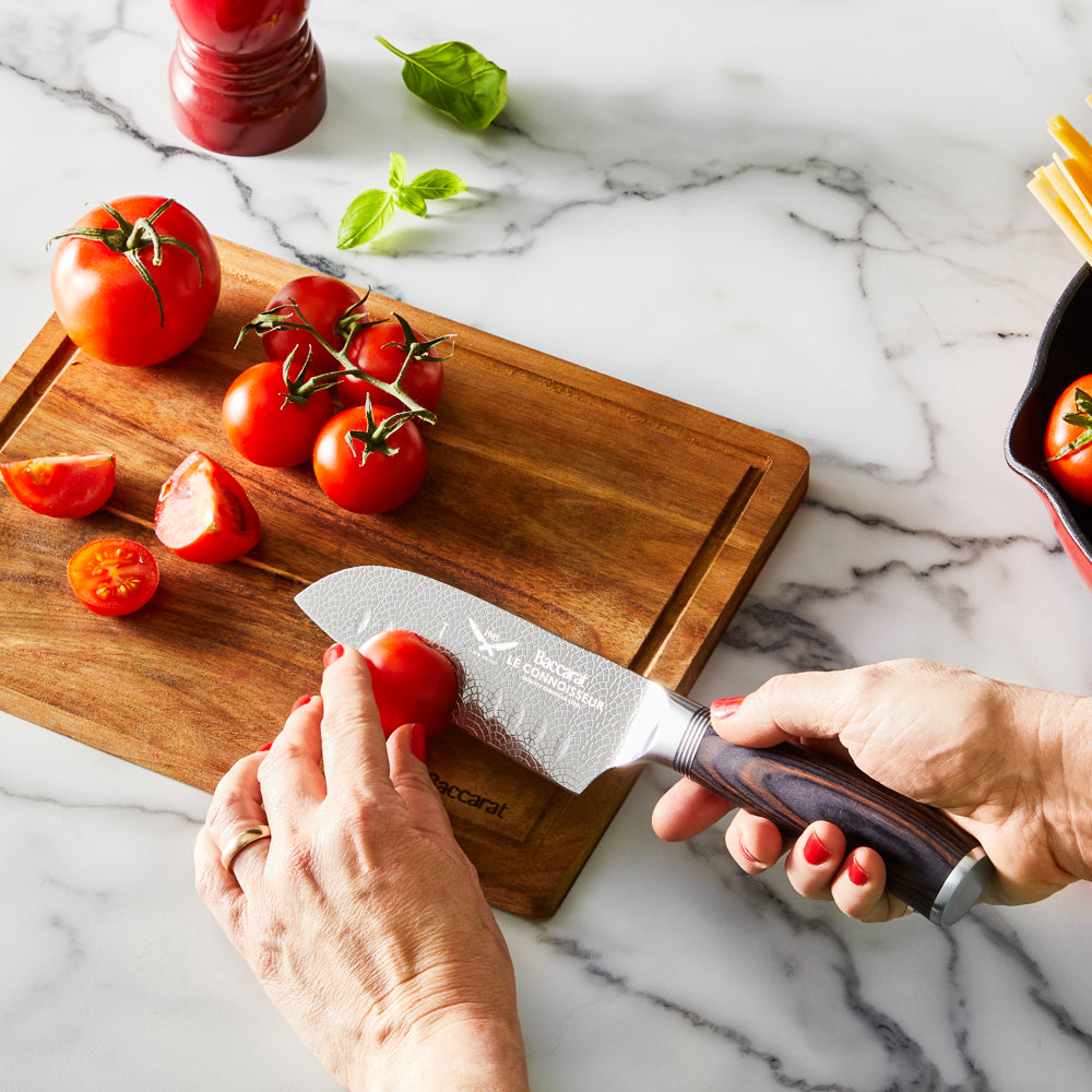 A knife slicing tomatoes on a wooden board silver blade carved handle 8l multicooker black - Epicure