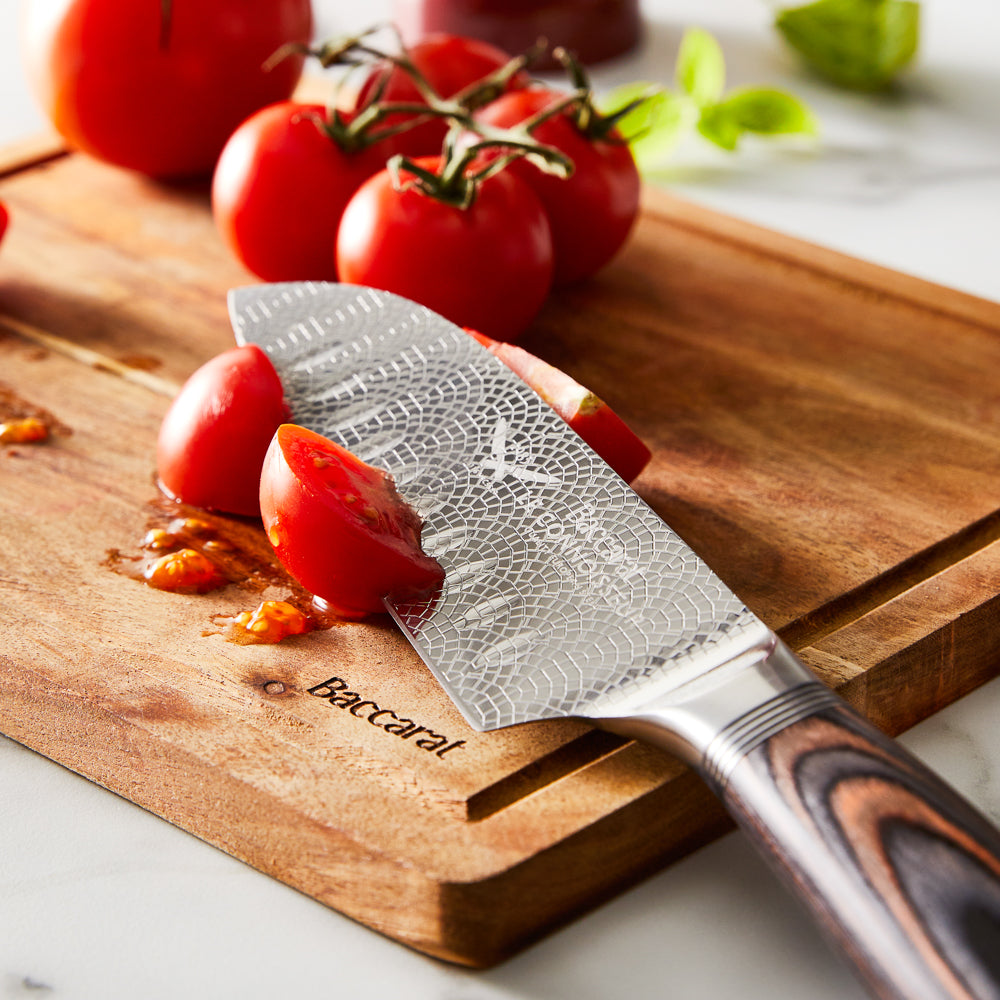 A knife slicing tomatoes on a wooden board silver blade carved handle 8l multicooker black - Epicure