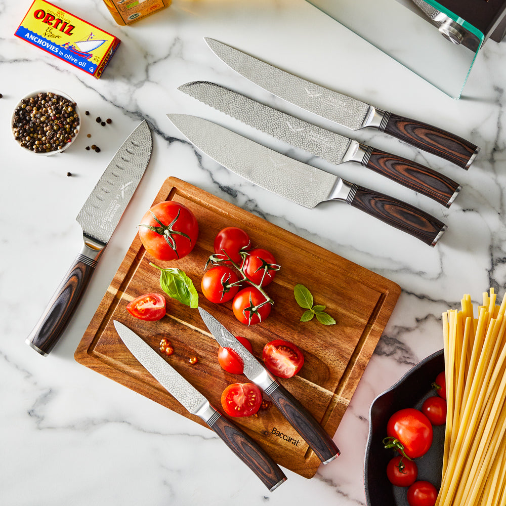 A knife slicing tomatoes on a wooden board silver blade carved handle 8l multicooker black - Epicure