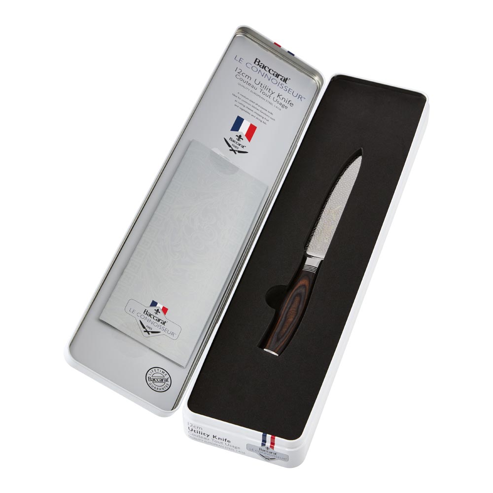 A sleek knife with a wooden handle inside an open silver box brown utility knife 12cm - Baccarat
