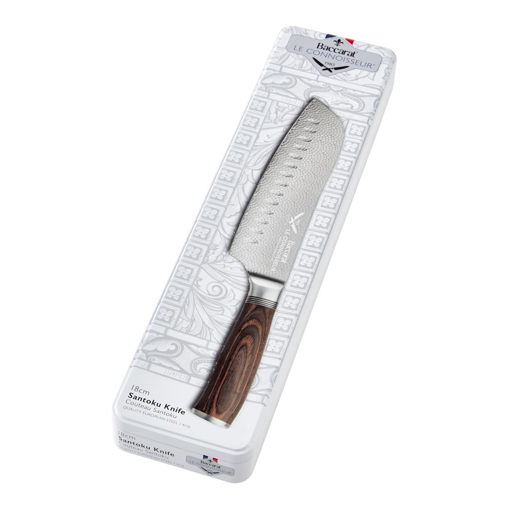 Hands slicing cured sausage on a black slate board metal knife food - Santoku knife 14cm - Baccarat