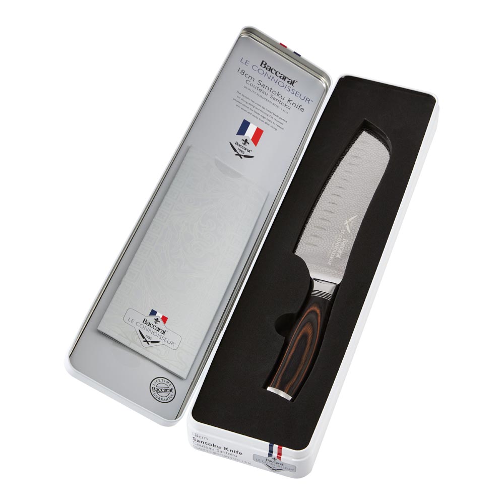Hands slicing cured sausage on a black slate board metal knife food - Santoku knife 14cm - Baccarat