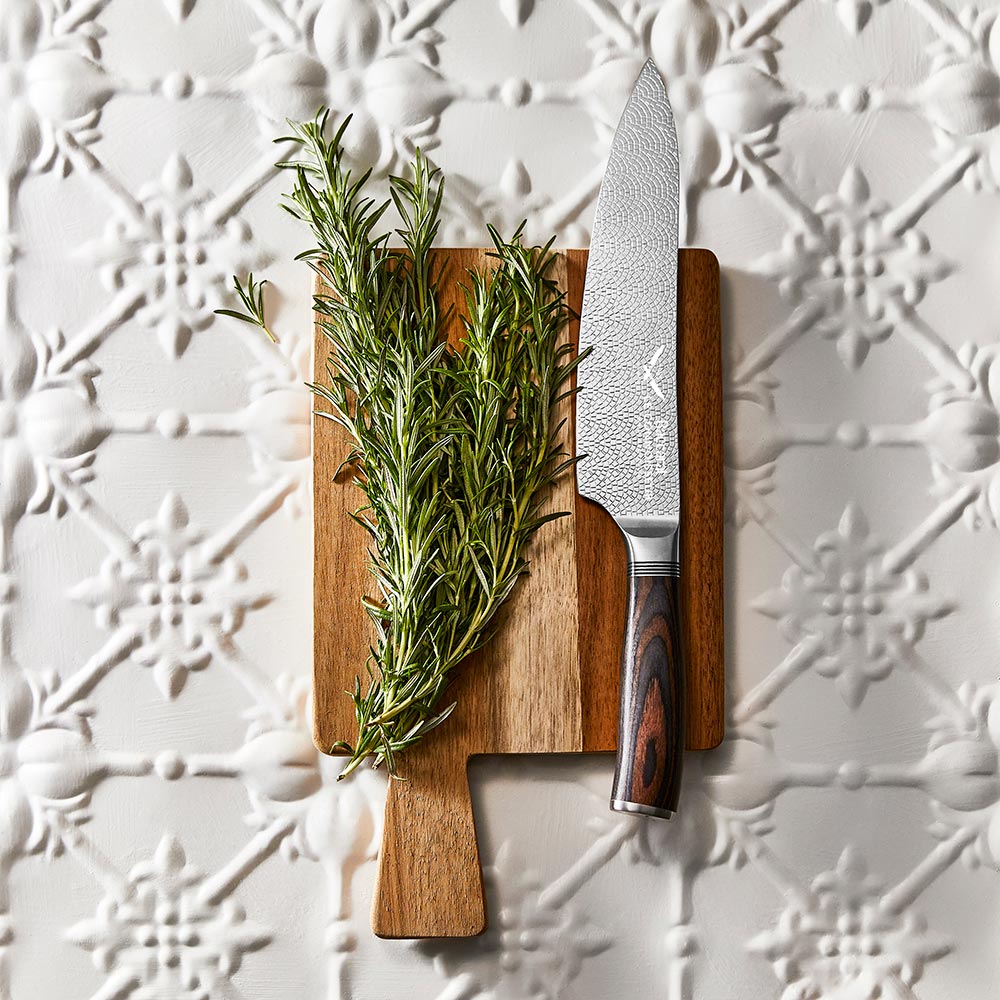 A sleek chefs knife with a sharp stainless steel blade and a dark wood handle colour 20cm - Baccarat