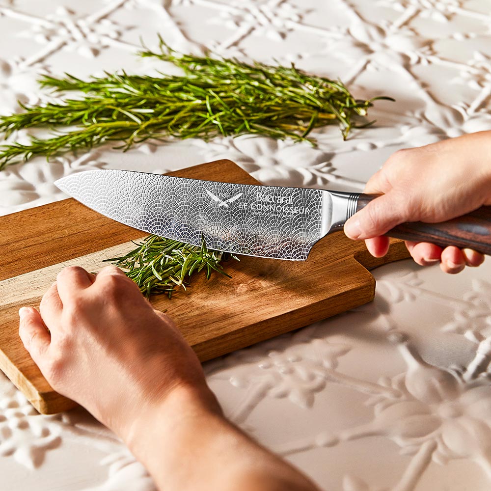 A sleek chefs knife with a sharp stainless steel blade and a dark wood handle colour 20cm - Baccarat