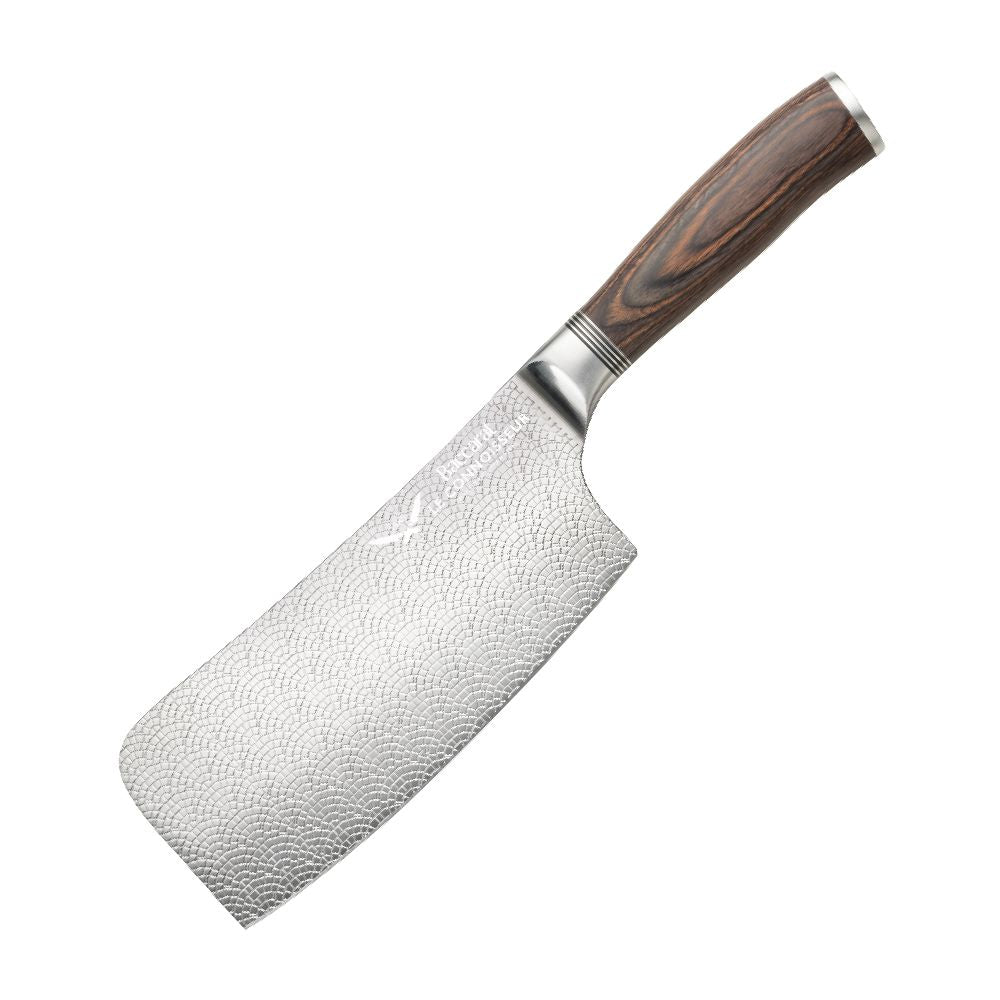 A hand slicing a red tomato with silver cleaver on a wooden cutting board - Baccarat Le Connoisseur