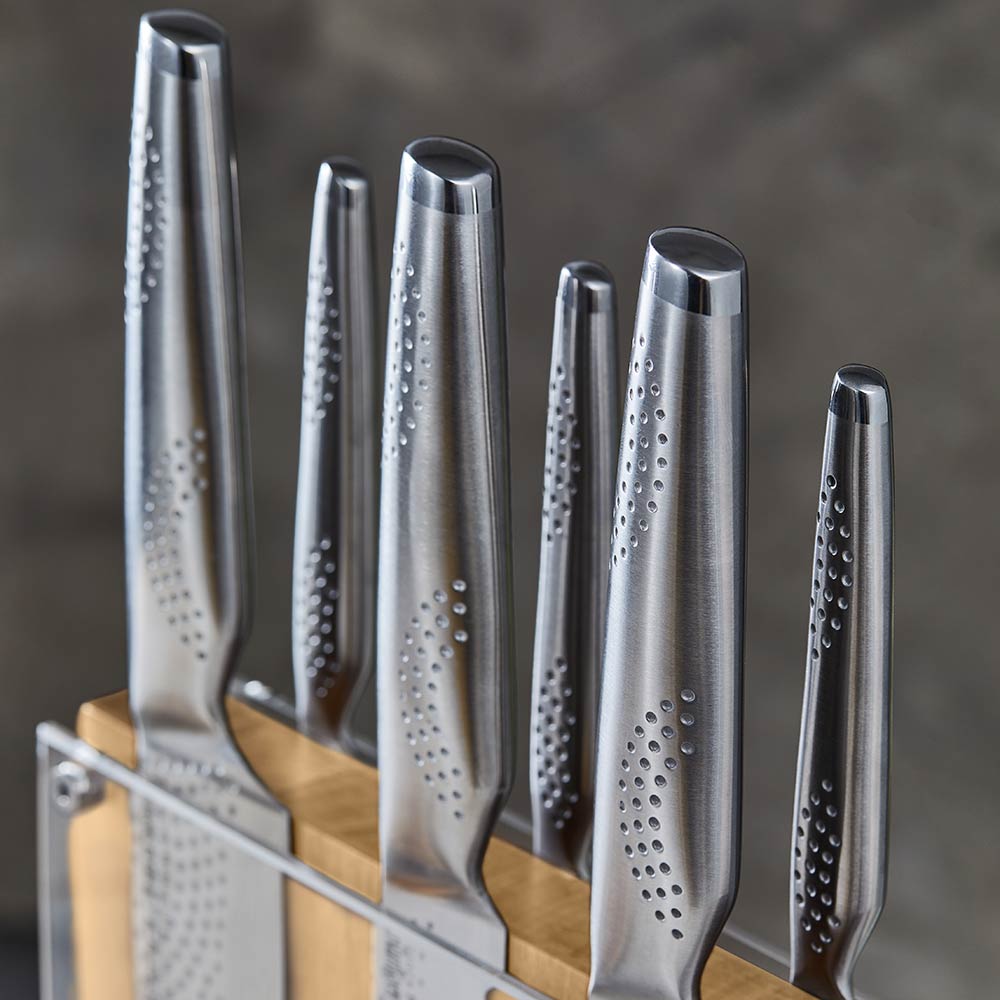 Knife set with silver blades displayed with fruit and nuts on table for precision cutting - Baccarat