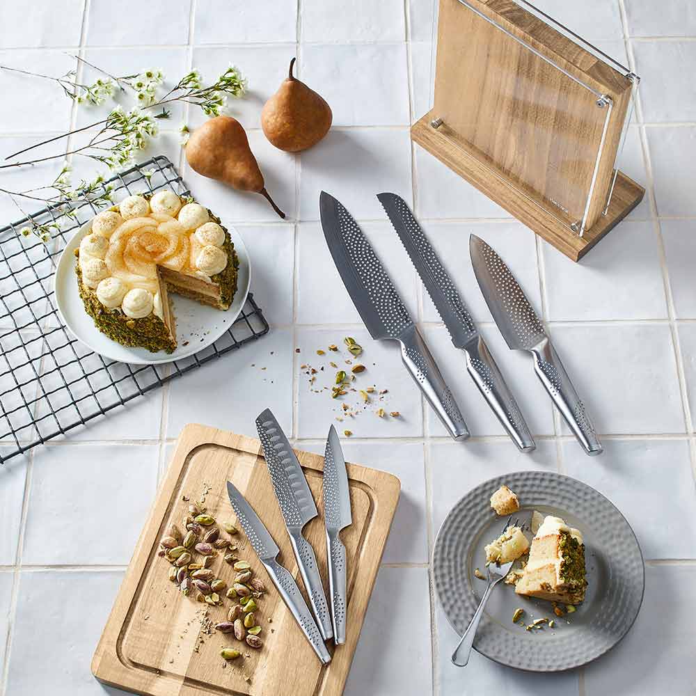 Knife set with silver blades displayed with fruit and nuts on table for precision cutting - Baccarat