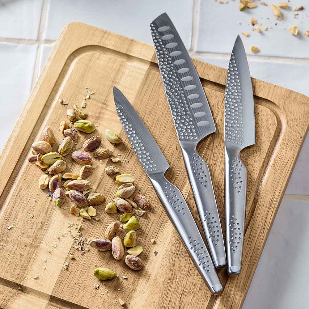 Knife set with silver blades displayed with fruit and nuts on table for precision cutting - Baccarat
