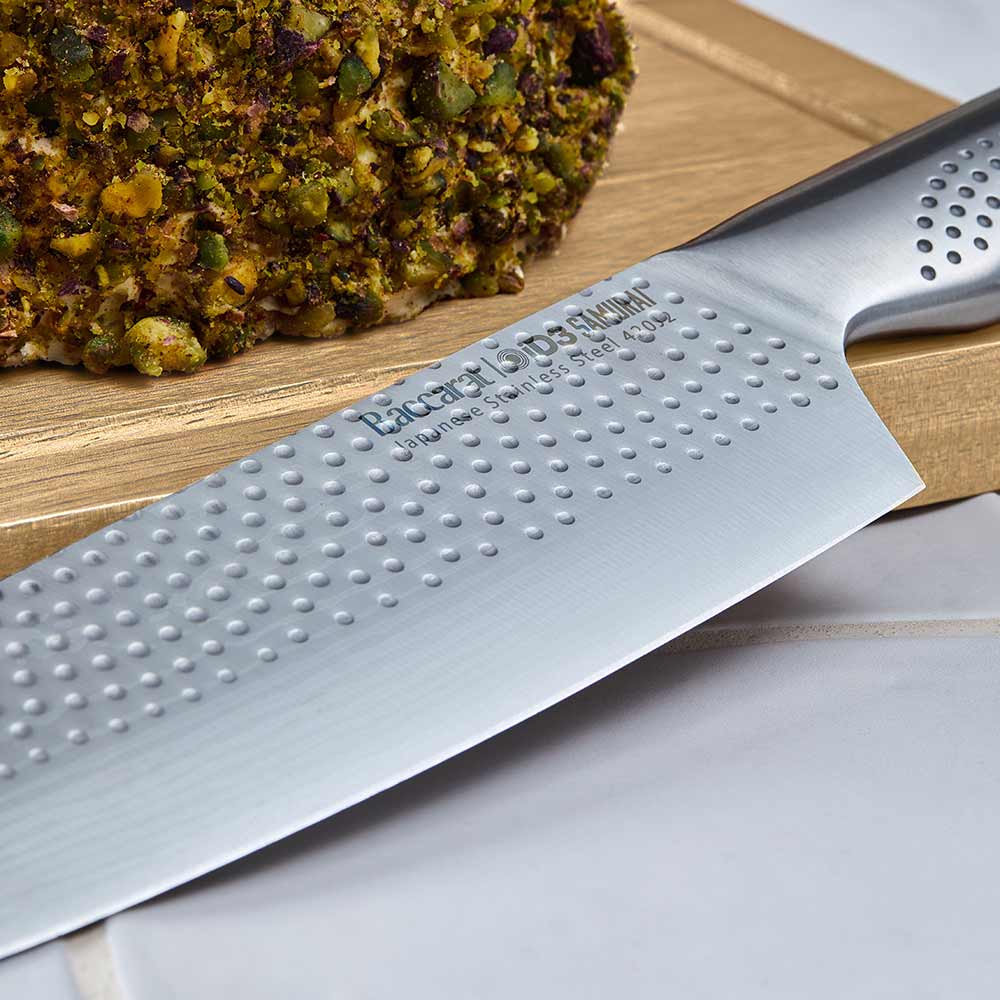 Knife set with silver blades displayed with fruit and nuts on table for precision cutting - Baccarat