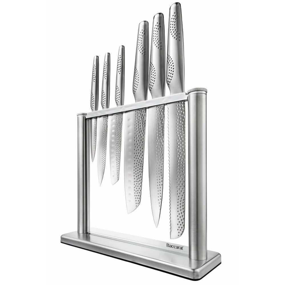 A polished knife block set with sharp blades and sleek design next to fresh vegetables - Baccarat