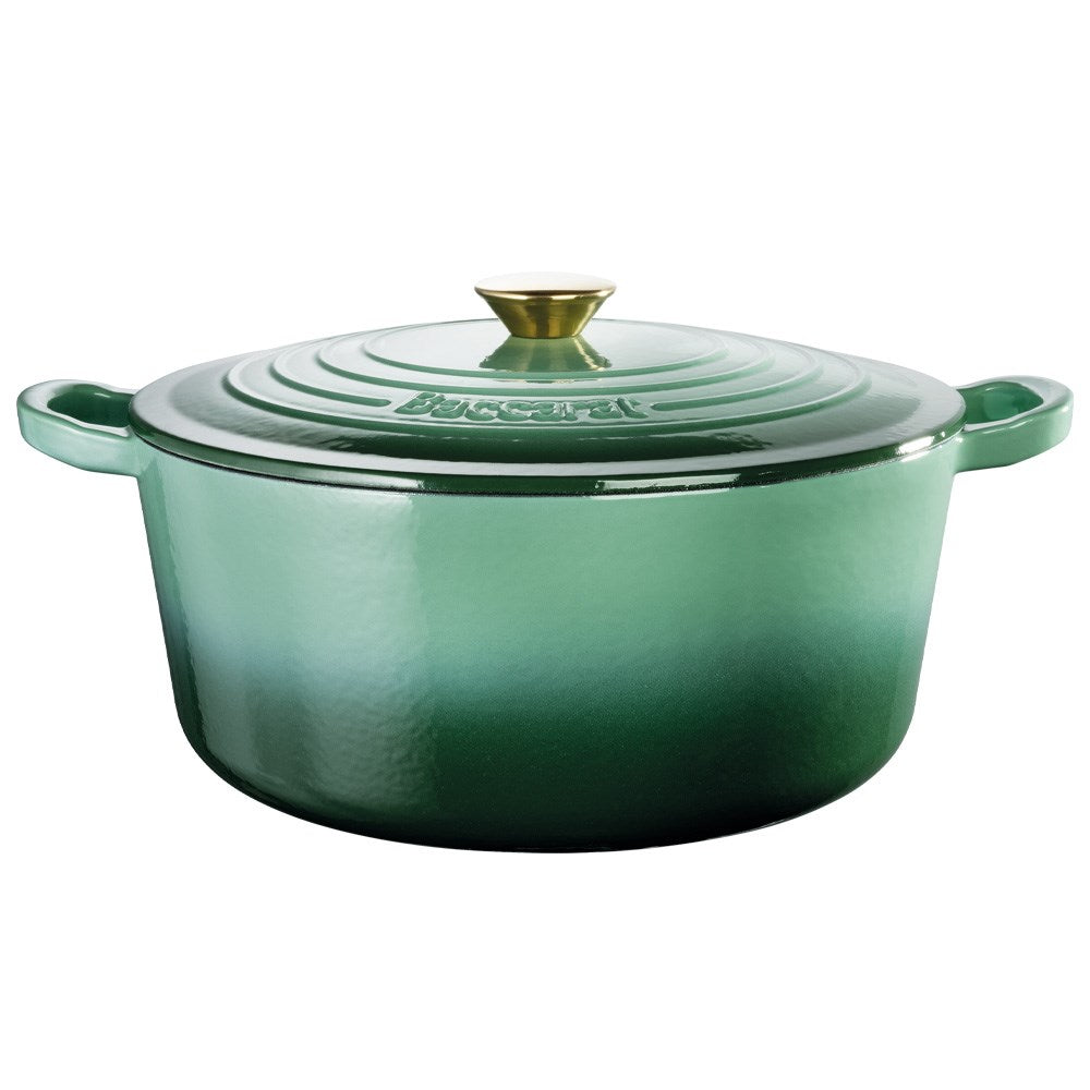 Green Baccarat Le Connoisseur French Oven with lid on countertop surrounded by herbs and a plant