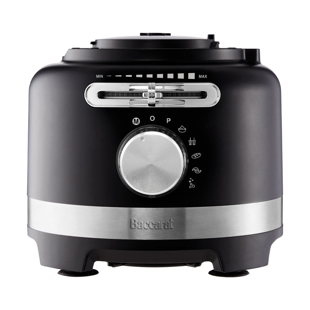 black air fryer with green ingredients on marble counter near dishes and a spice grinder - Baccarat