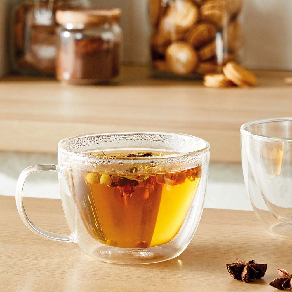 A glass cup filled with dark amber tea transparent beverage container - Baccarat barista brillante