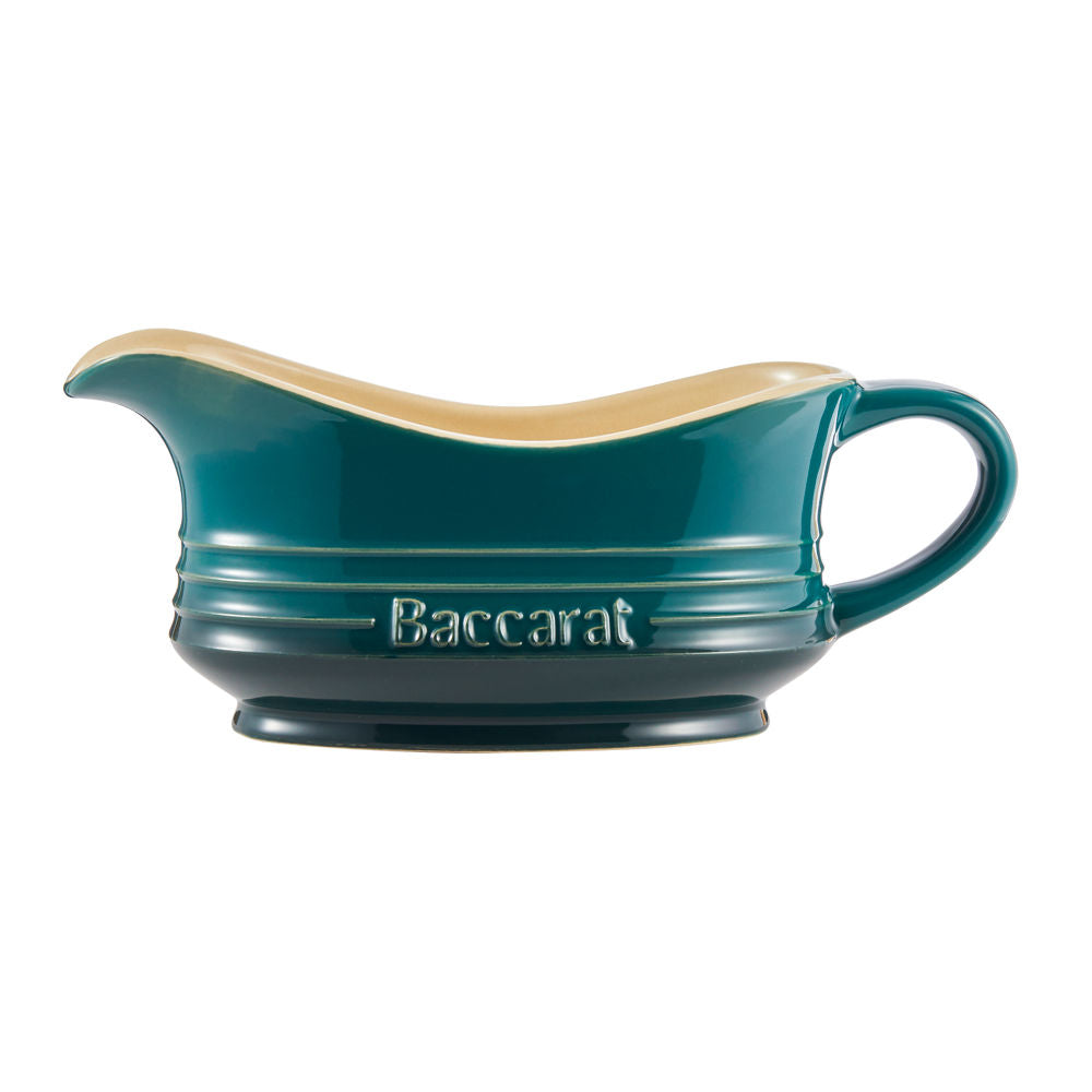 A teal ceramic gravy boat with a cream interior featuring a side handle teal gravy boat - Barista