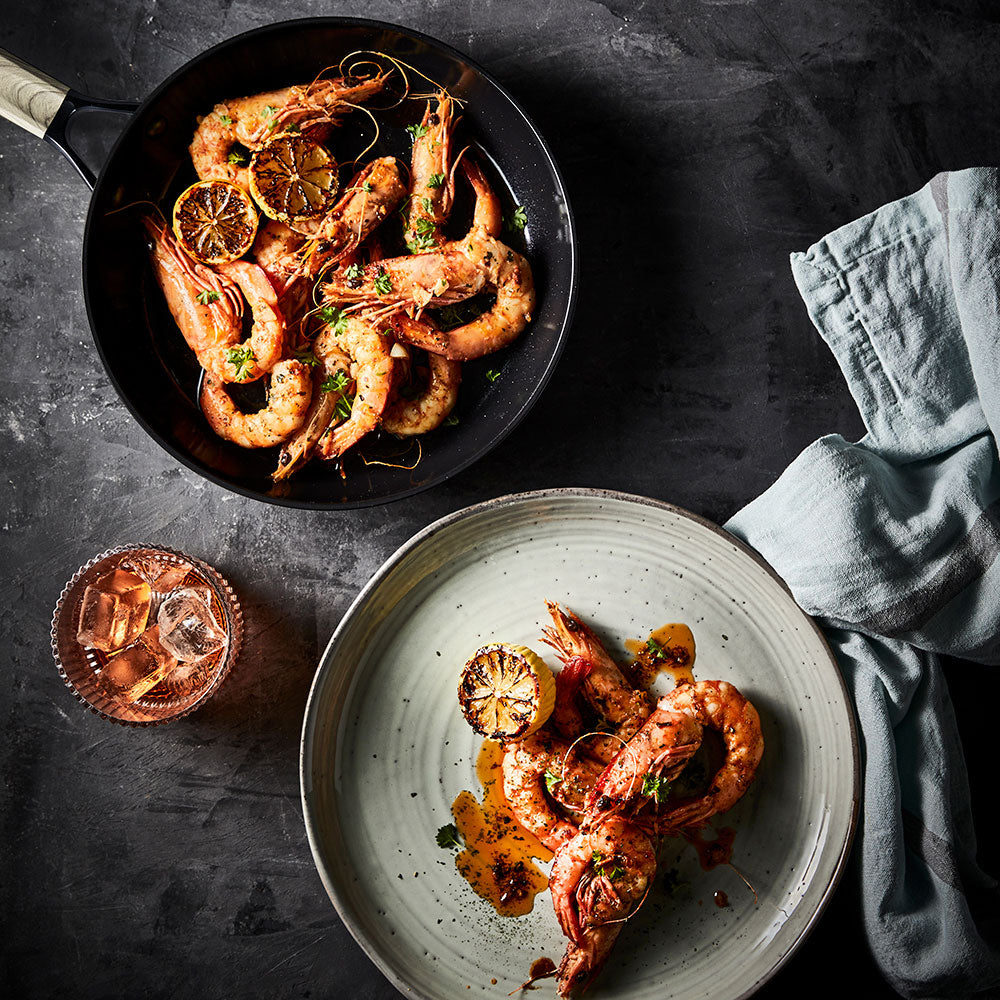 prawns in a skillet with herbs dark theme round french saute pan 31cm - le connoisseur