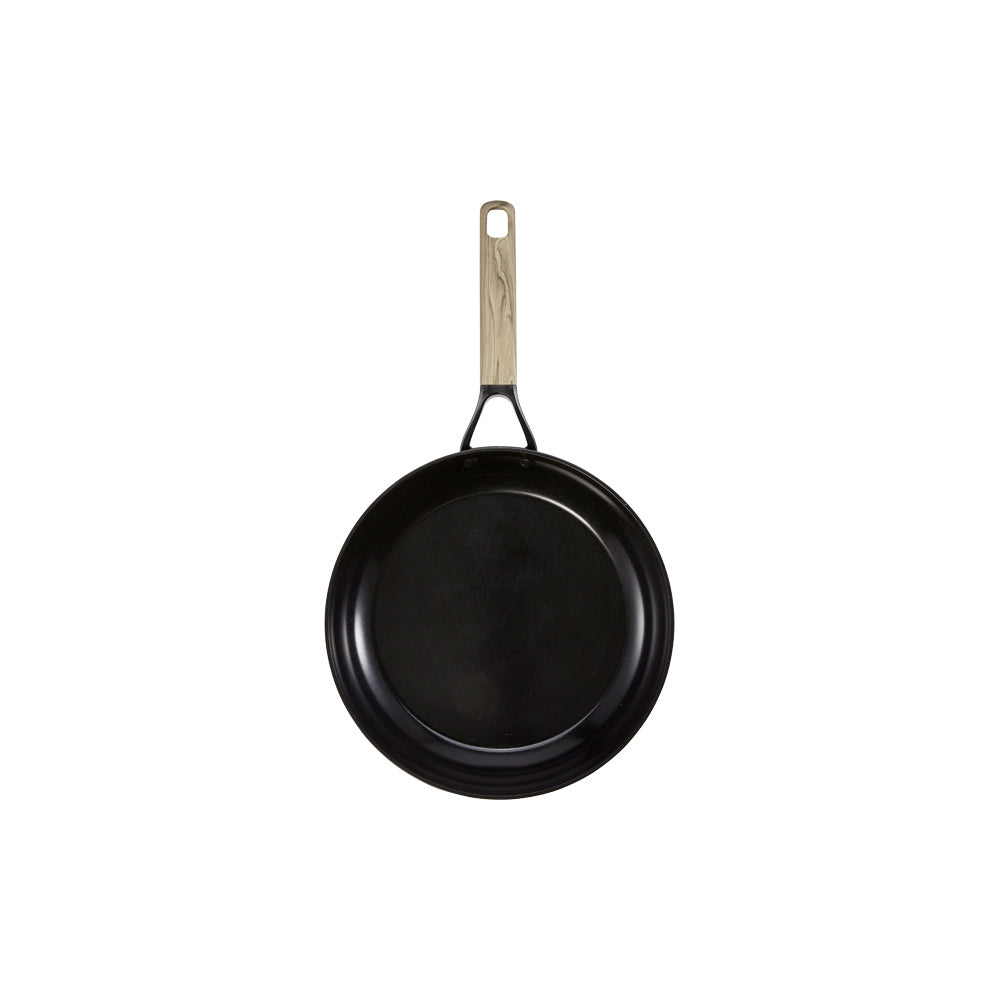 Pancakes in skillet next to syrup topped pancakes on plate non stick frypan 24cm - Baccarat