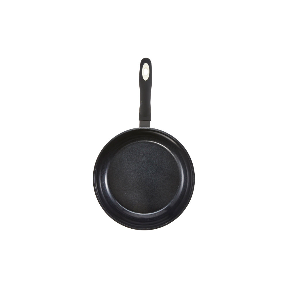 Aerial view of a black non-stick frying pan with a long handle cream non-stick frying pan - Baccarat