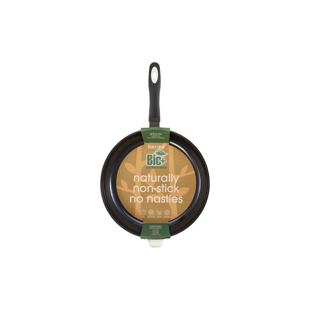 A 32-cm Baccarat Bio Frying pan containing pasta on a wooden board surrounded by fresh ingredients