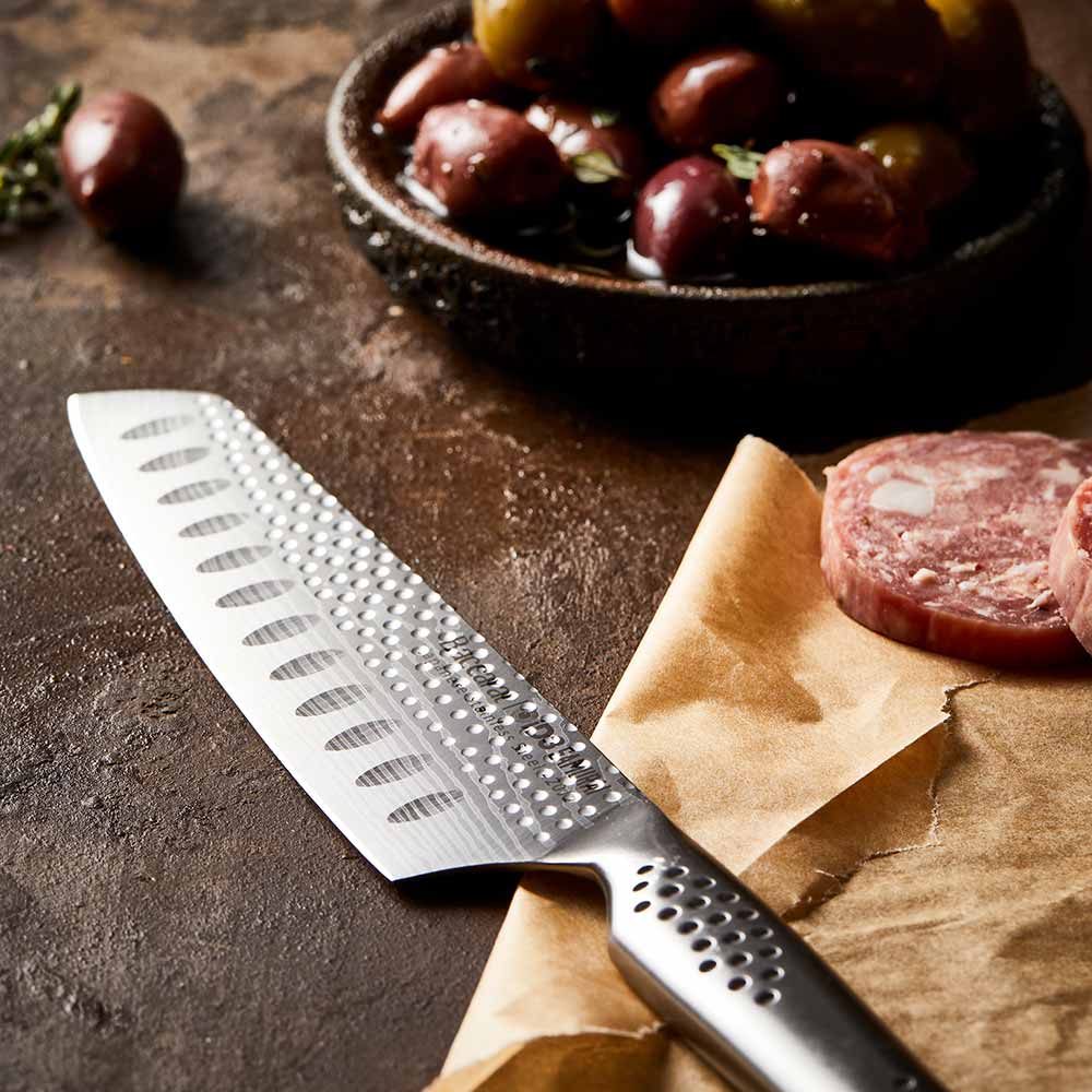 Shiny silver santoku knife with a 12 5cm blade reflecting on a surface - Baccarat id3 Samurai try me