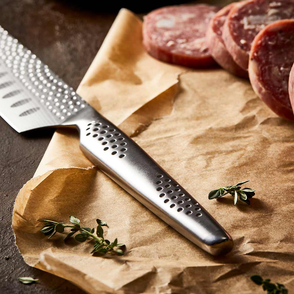 Shiny silver santoku knife with a 12 5cm blade reflecting on a surface - Baccarat id3 Samurai try me