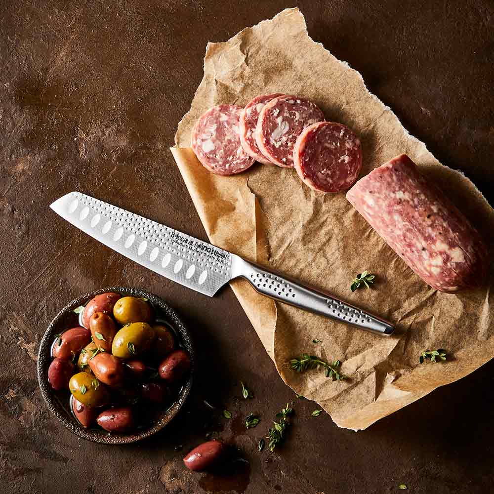 Shiny silver santoku knife with a 12 5cm blade reflecting on a surface - Baccarat id3 Samurai try me