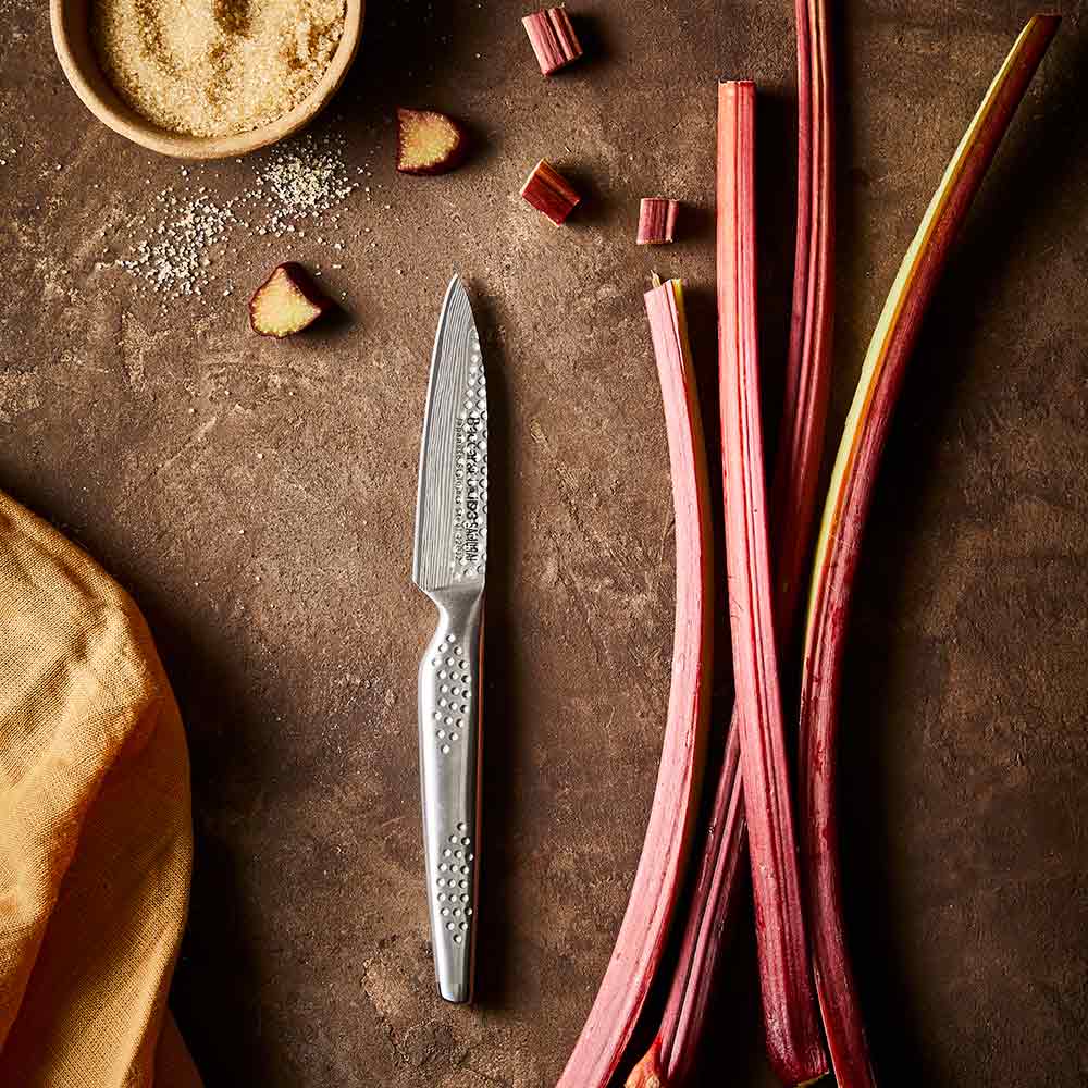 Textured blade knife on wood next to rhubarb chunks and brown sugar ceramic non stick - Stonex2