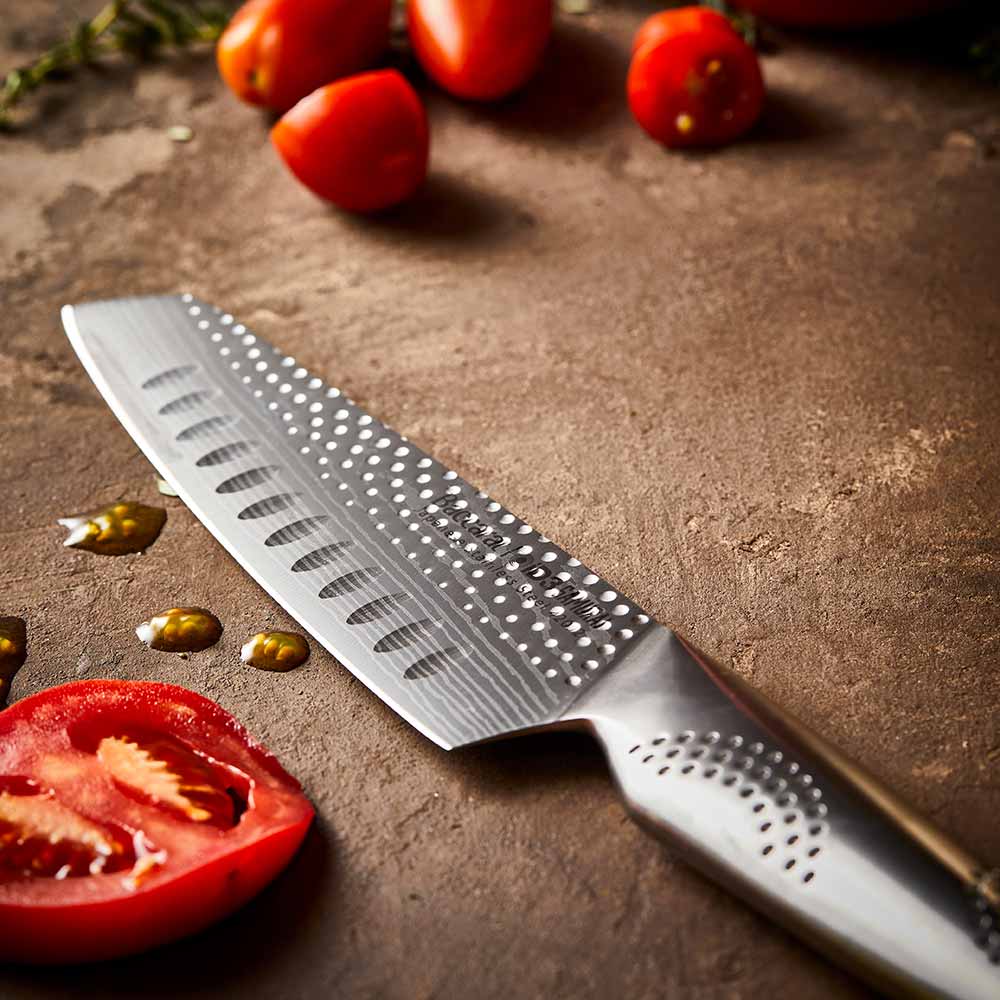 Fresh tomatoes in a wooden bowl with a silver knife on a brown surface - 11cm knife Samurai Santoku