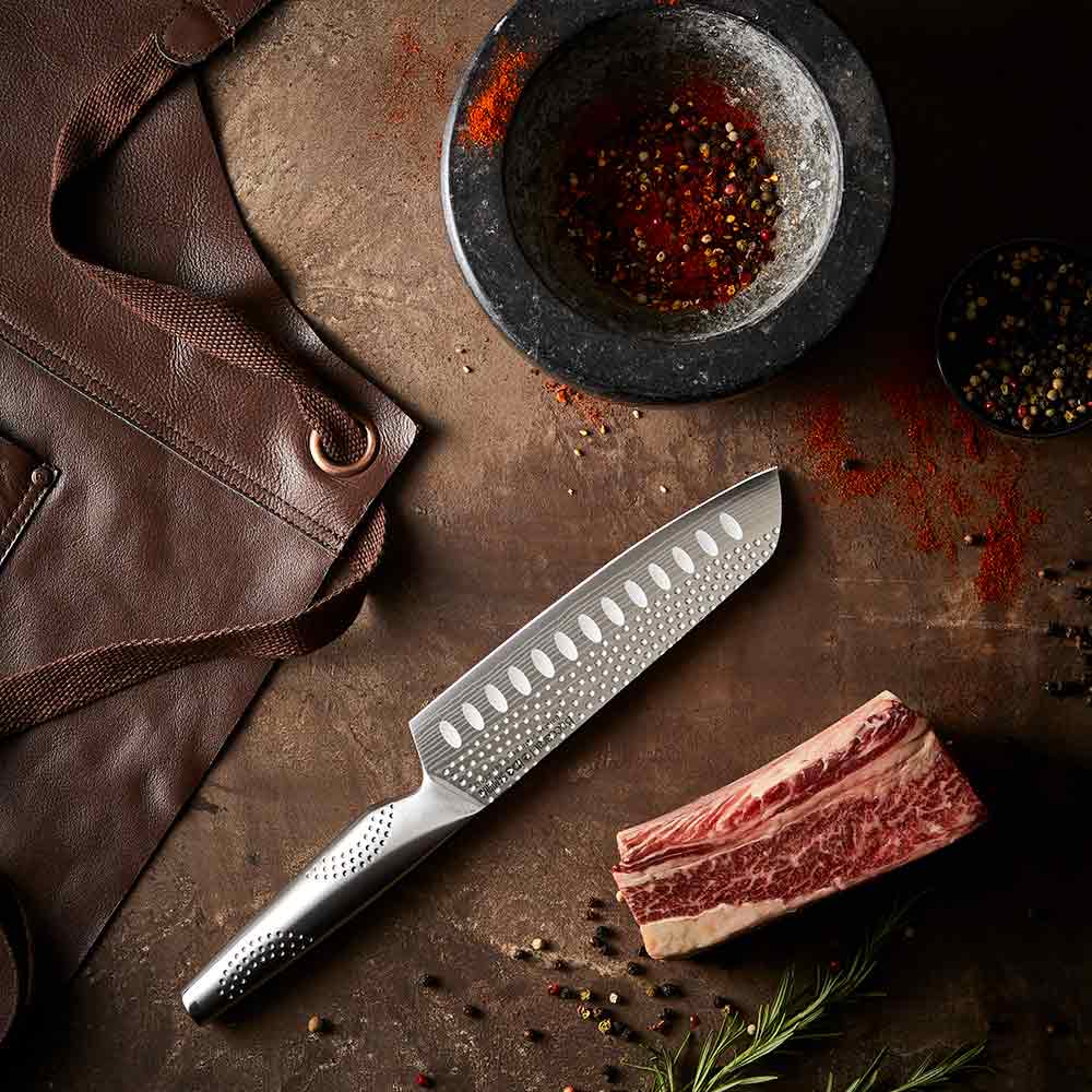 A sharp stainless steel kitchen knife on a white background featuring a silver blade 15cm - Baccarat