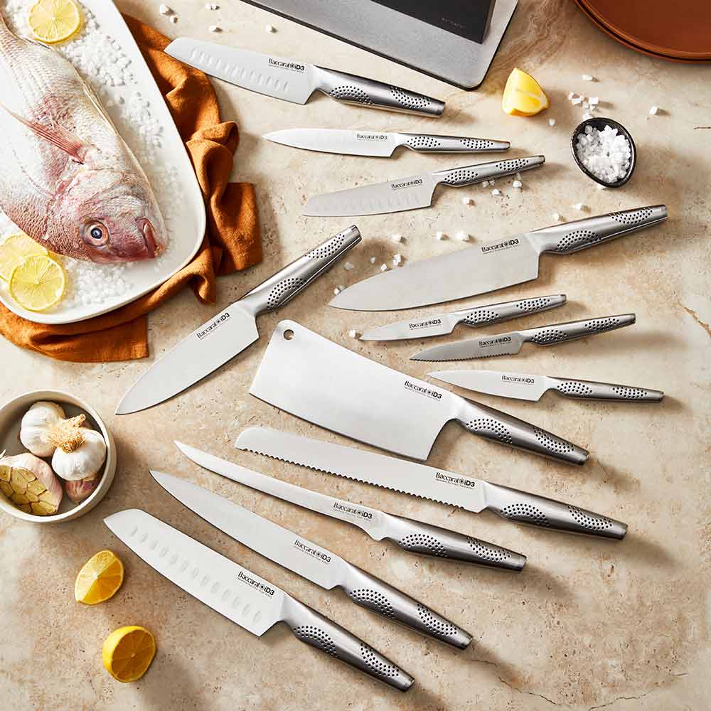 A close-up of a silver stainless steel knife on a wooden cutting board stainless steel knife - Kachi