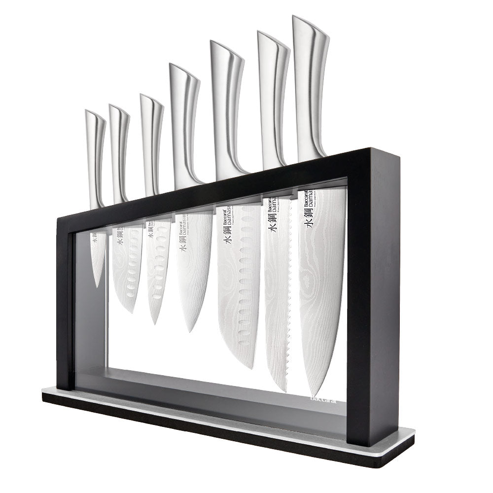 Close-up of Baccarat Damashiro Satori kitchen knife with a patterned blade on a grey countertop