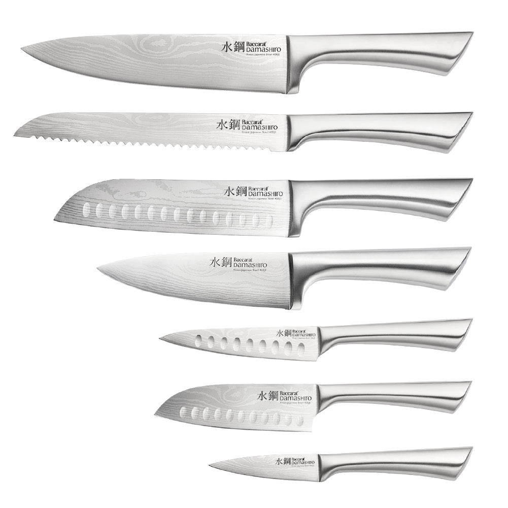 Close-up of Baccarat Damashiro Satori kitchen knife with a patterned blade on a grey countertop