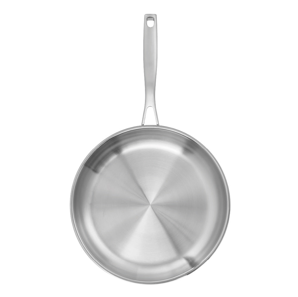 A stainless steel frying pan with a textured handle sits on a wooden board - frypan 26cm - Baccarat