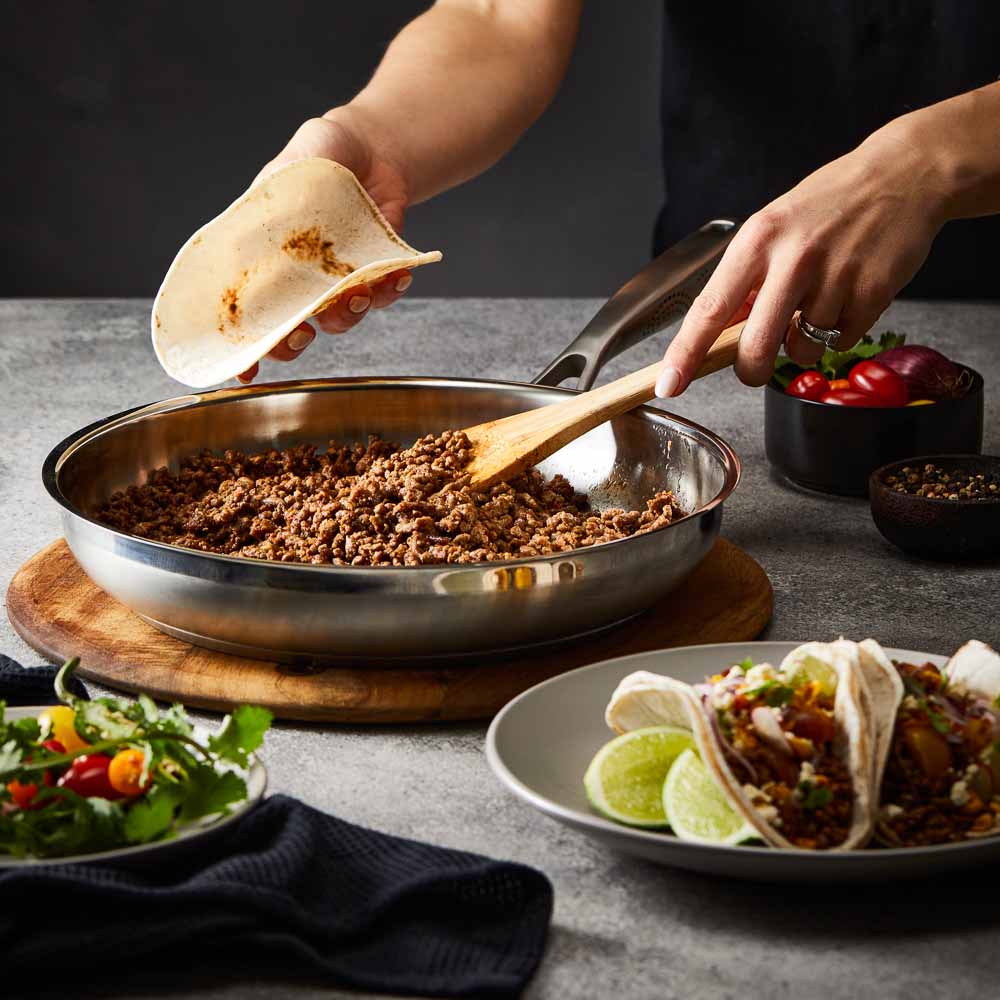 Baccarat id3 Stainless Steel 30cm Frypan with cooked ground beef on a table with tacos and salad