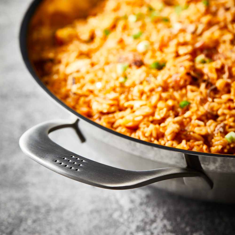 Person serving gourmet pasta from a black bowl - Baccarat id3 stainless steel chef pan with lid 32cm