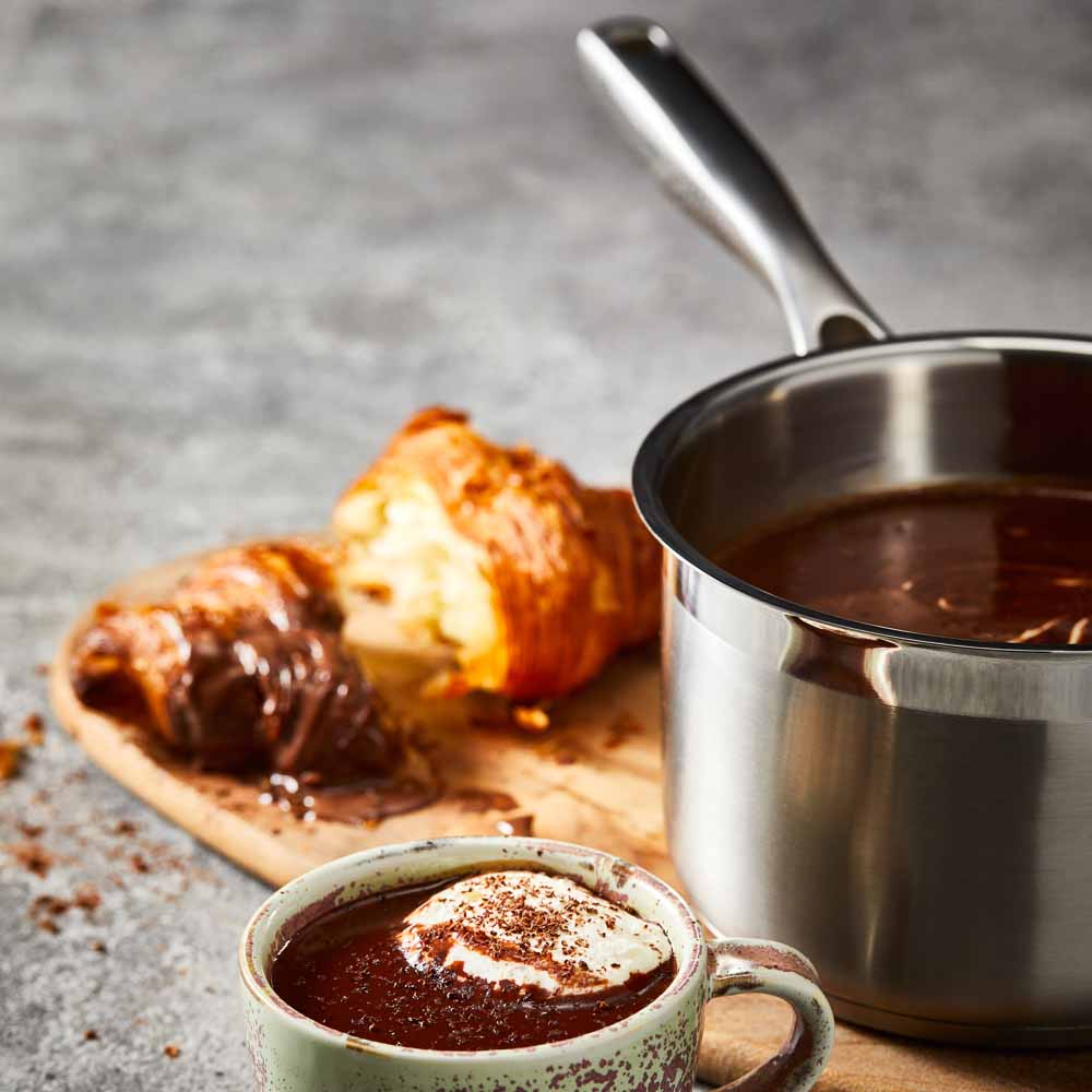 A stainless steel pot with a lid on wooden surface silver cookware 16cm saucepan with lid - Baccarat