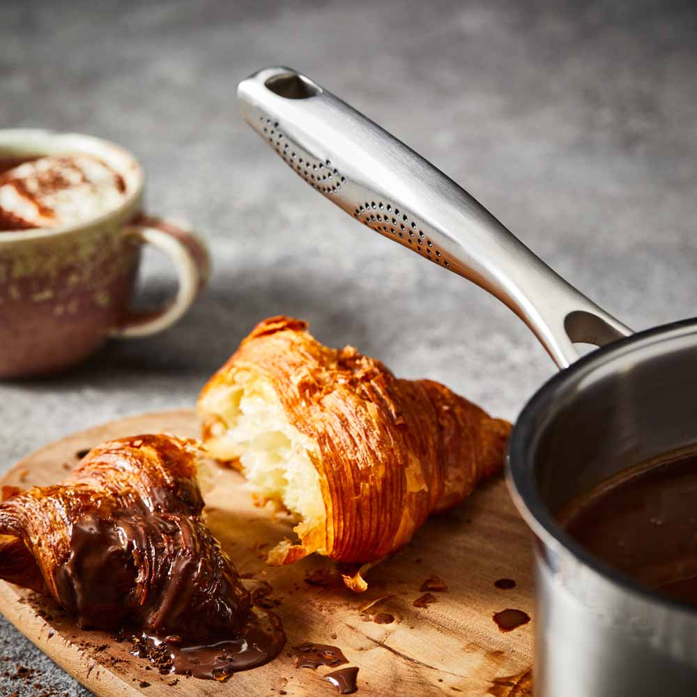 A stainless steel pot with a lid on wooden surface silver cookware 16cm saucepan with lid - Baccarat
