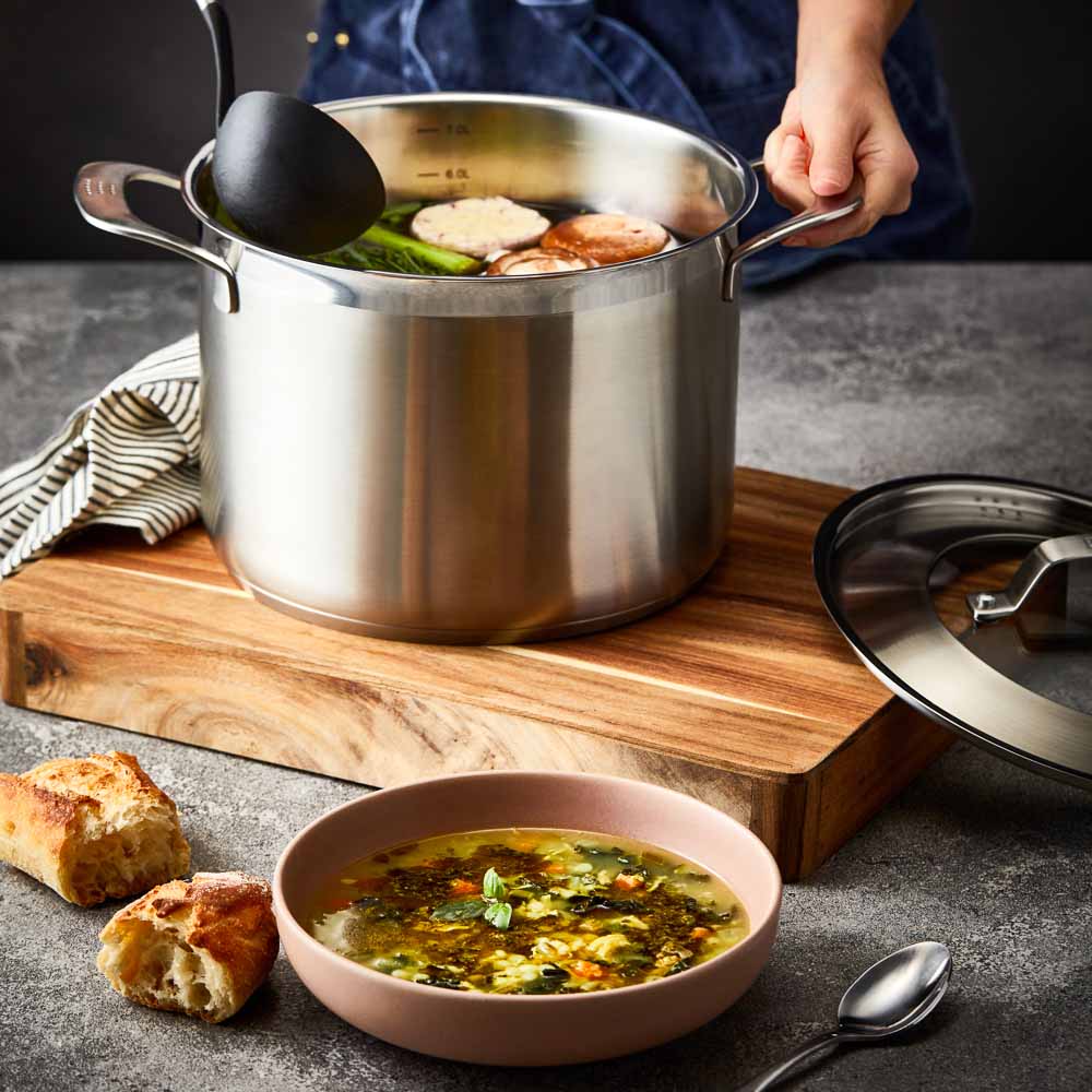 Close-up of a stainless steel pot lid with a handle and steam holes modern cookware 24cm - Baccarat