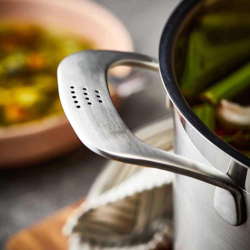 Close-up of a stainless steel pot lid with a handle and steam holes modern cookware 24cm - Baccarat