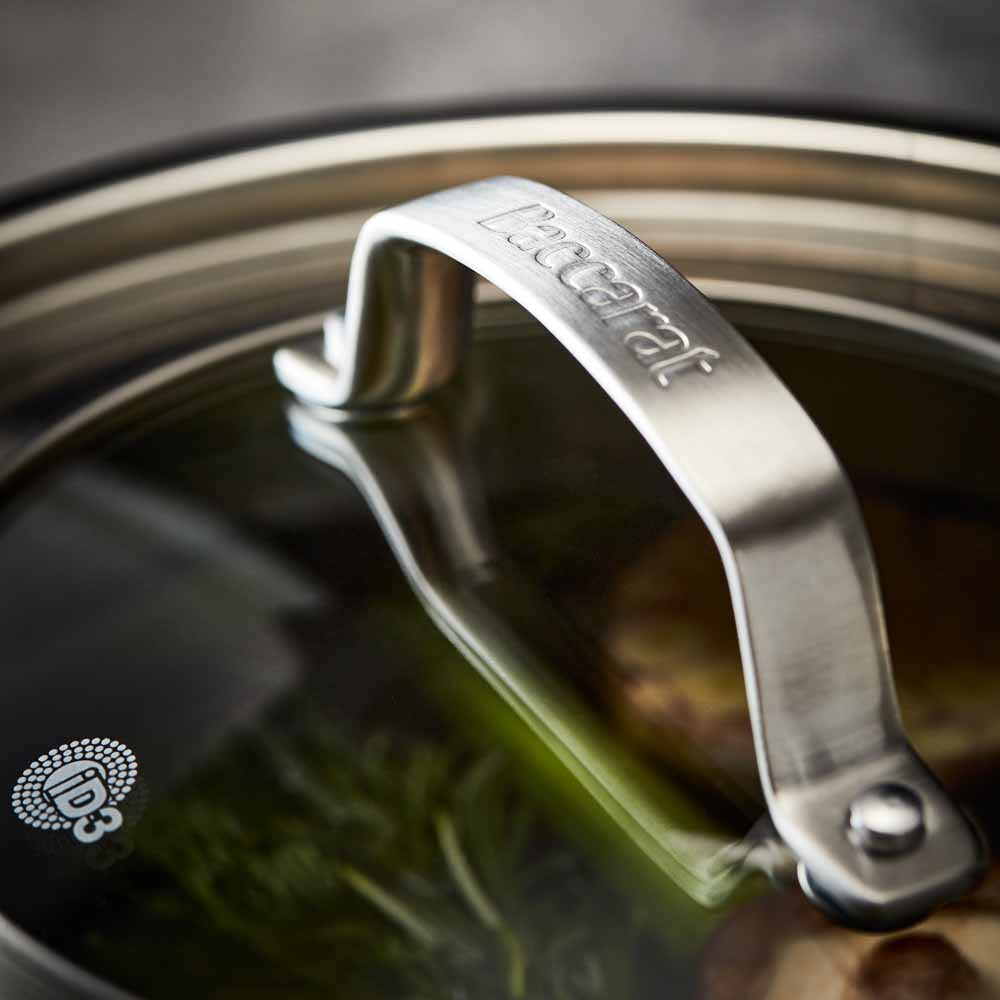 Close-up of a stainless steel pot lid with a handle and steam holes modern cookware 24cm - Baccarat