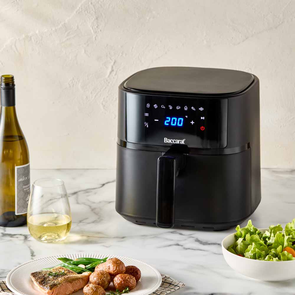 A black air fryer with digital display sits on a marble countertop - Baccarat Compact Air Fryer 5 7l