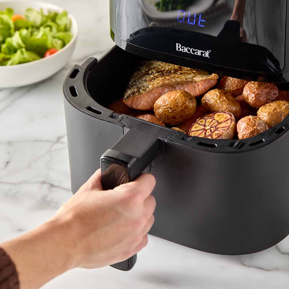 A black air fryer with digital display sits on a marble countertop - Baccarat Compact Air Fryer 5 7l