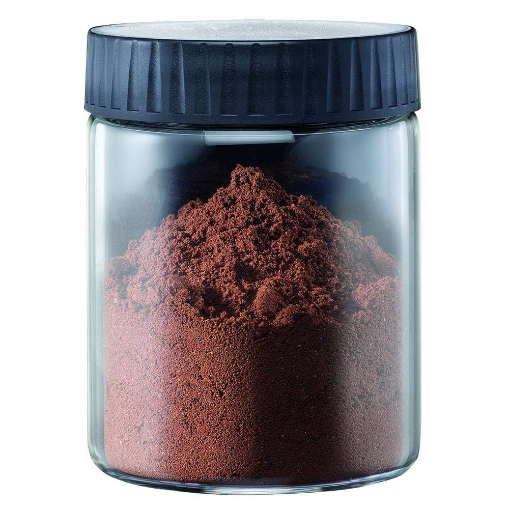 Elegant manual coffee grinder with a sleek transparent base filled with ground coffee - Baccarat