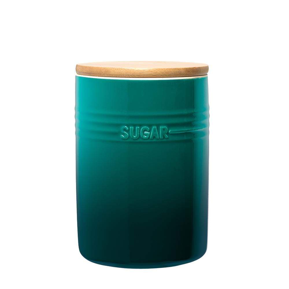 A stylish set of three cylindrical teal ceramic canisters with wooden lids - Baccarat