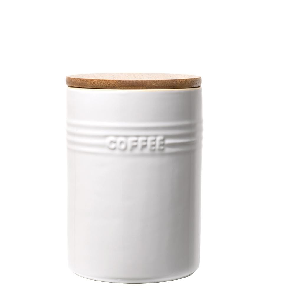A set of three white ceramic canisters with elegant lids and a sleek design - Baccarat