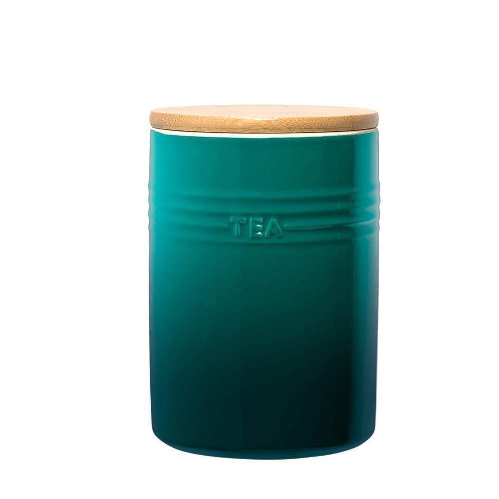 A stylish set of three cylindrical teal ceramic canisters with wooden lids - Baccarat